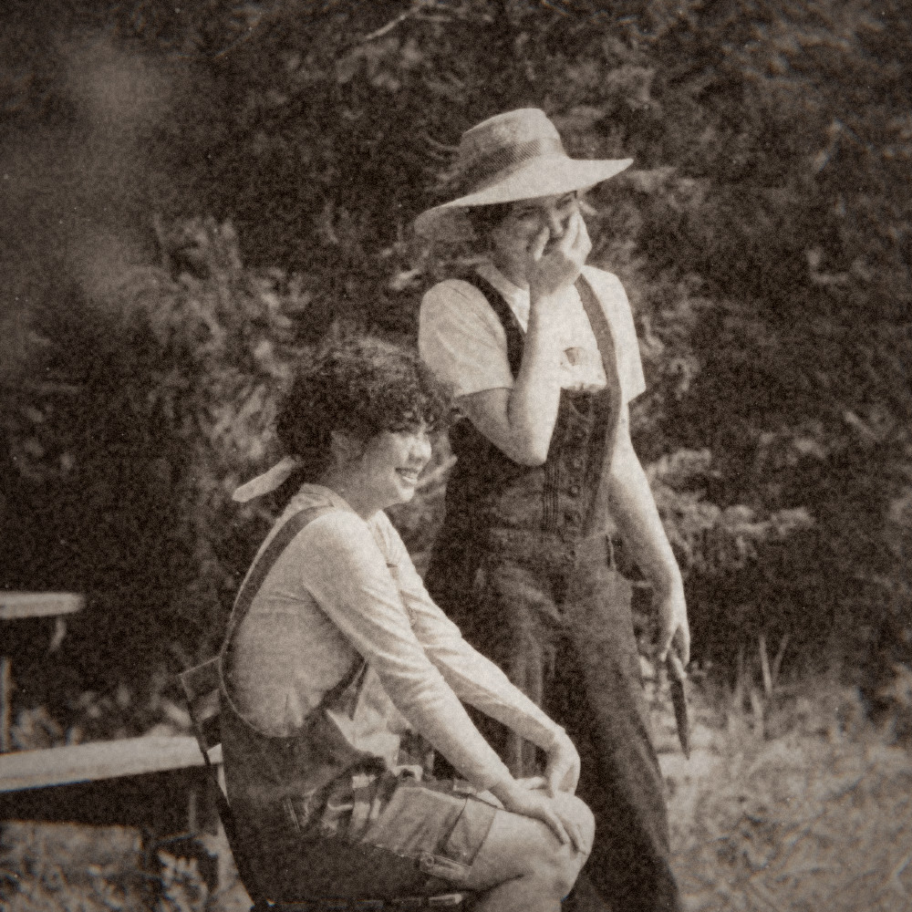 Two friends laughing in a garden, 1895 look